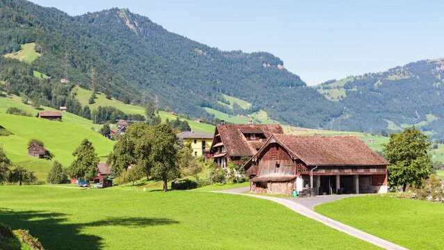 Switzerland, canton of Schwyz, Lauerz, panoramic view of a barn surrounded by lawn and view of Lake Lauerz, surmounted by Mount Rigi