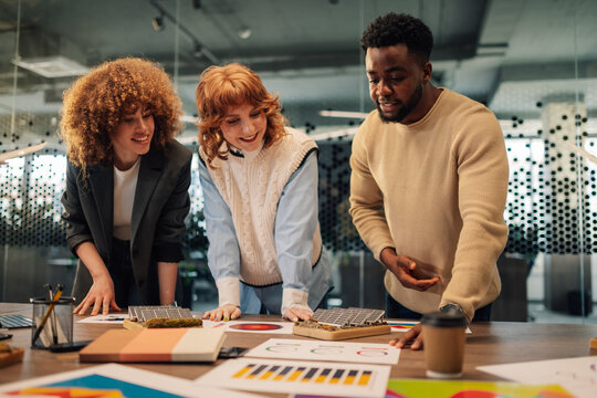 Diverse team analyzing data and charts for solar power energy project