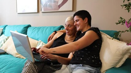 Lesbian Couple Enjoying Internet Browsing on Laptop - Powered by Adobe