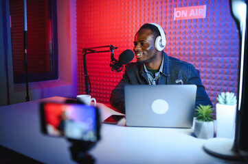 African american video blogger records content in his studio.