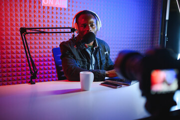 African american video blogger records content in his studio.
