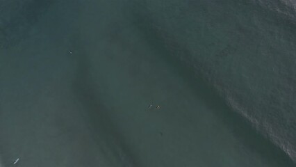 surfer catching wave down