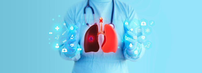 The doctor analyzes lung cancer on a light blue background through a 3D hologram of the lungs....