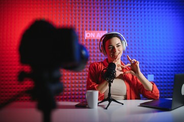 Young creative woman live streaming a video for her followers on social media