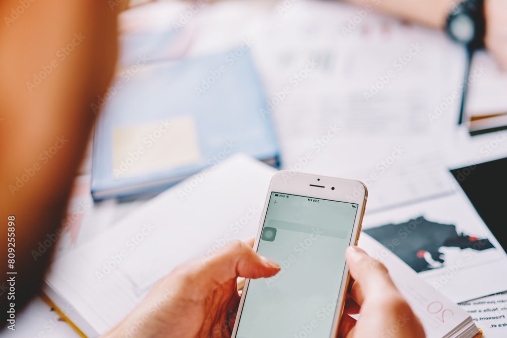 Poster cropped view of young man updating profile and making payment online on website on modern smartphone
