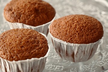Close up of freshly baked cupcakes on top of glass tray.