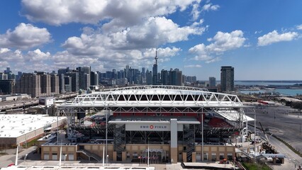 Naklejka premium BMO Field inToronto and the amazing city skyline in the background - aerial view - TORONTO, CANADA - APRIL 17, 2024
