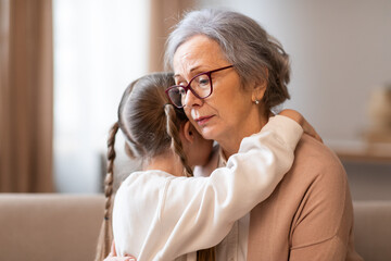A tender moment between a grandmother and her granddaughter as they embrace in a gentle hug. The...