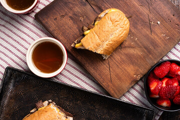 French dip sandwich with smoked gouda cheese.  Sides of au jus and fresh strawberries.