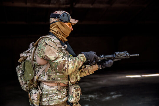 Soldier in camouflage with a machine gun