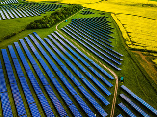 Aerial shot of large solar farm surrounded by farmers fields