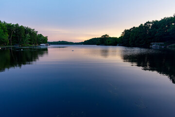 Looking onto a calm Wisconsin lake in the evening as the sun goes down.