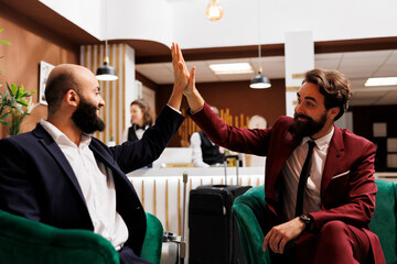 Business people team does highfive after successful international meeting, creating new corporate...