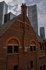 old brick building and modern skyscrapers