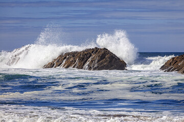 Crashing waves over offshore rocks on the Pacific coast of central Oregon, USA.