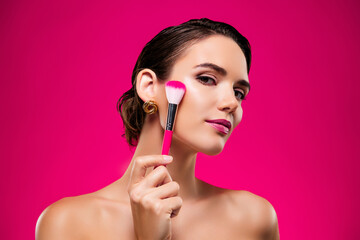 Photo portrait of attractive young woman apply brush face shoulders off isolated on pink color...