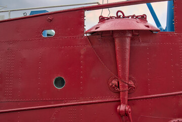 red boat anchor close up attached to boat (detail macro view of boats parts) detailed photography...