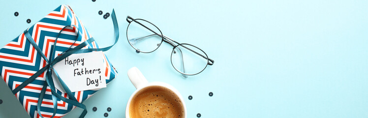 Happy Fathers Day banner mockup. Flat lay vintage gift box with label Happy Father's Day, glasses, coffee cup on blue background with copy space.
