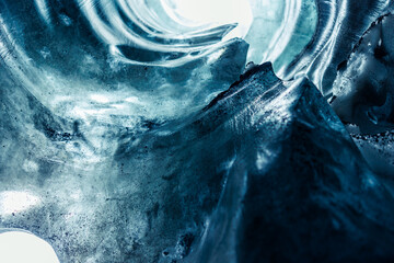 Massive ice blocks inside crevasse, vatnajokull glacier with transparent cracked texture in...