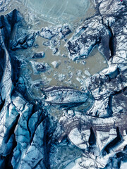 Aerial view of magnificent Vatnajokull ice blocks in Iceland and massive icebergs in arctic countryside scenery. Icy cold lake and snowy peaks with blue glaciers and frigid rocks.