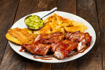 Grilled mamona beef with fries and patacon plantain - Typical Colombian food