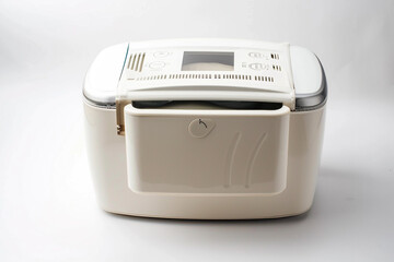 A compact bread maker featuring a removable kneading paddle and a viewing window isolated on a solid white background.