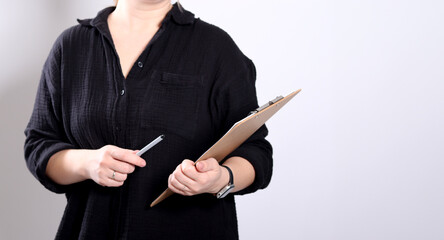 Close up of a woman holding a clipboard on white background