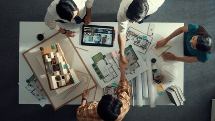 Top view of skilled architect engineer working together and shaking hand cooperative team while...