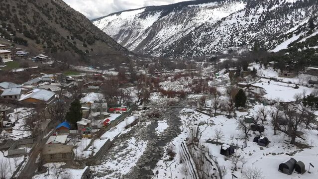 Scenic Kalasha Village in Bamburet Valley in North Pakistan at Winter. Aerial View Hindu Kush Muntain Range Himalayas.