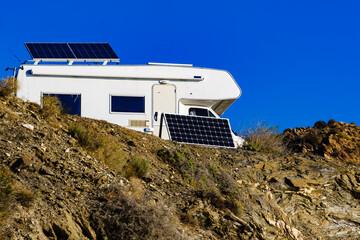 Caravan with tilt solar panels on roof.