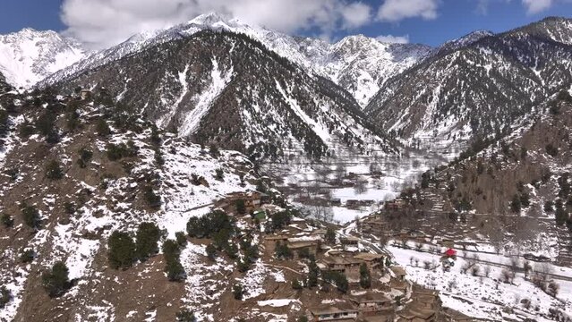 Scenic Kalasha Village in Bamburet Valley in North Pakistan at Winter. Aerial View Hindu Kush Muntain Range Himalayas.
