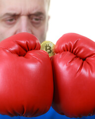 Man in boxing gloves holding bitcoin