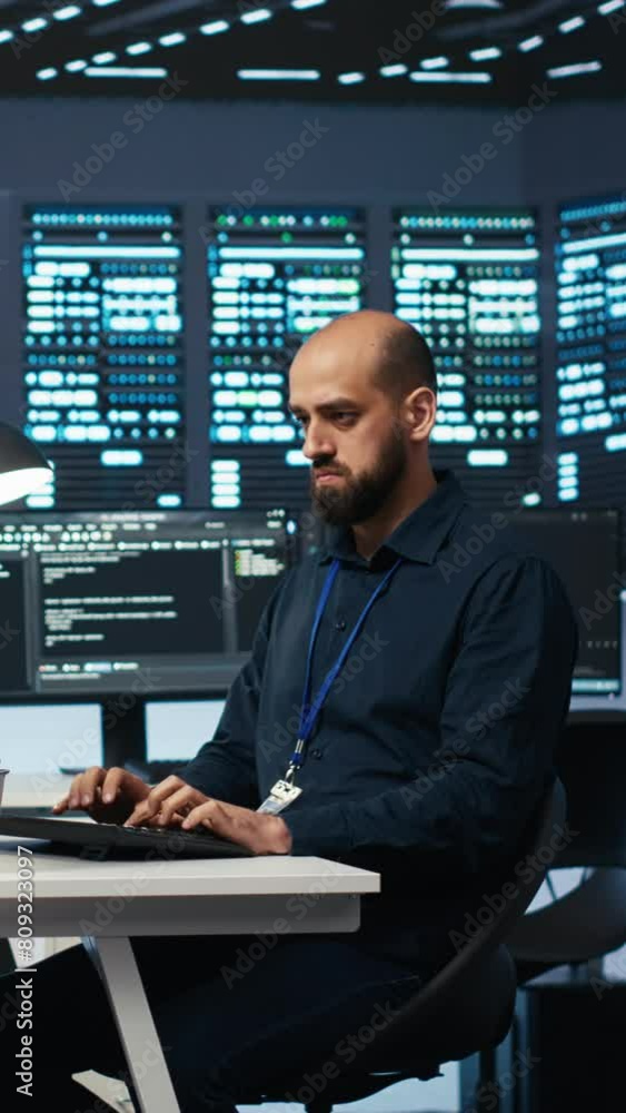 Aufkleber vertical video experienced person typing code on computer monitors in high tech facility with server