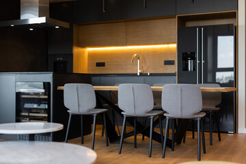 Luxury kitchen and dining room interior with brown parquet floor
