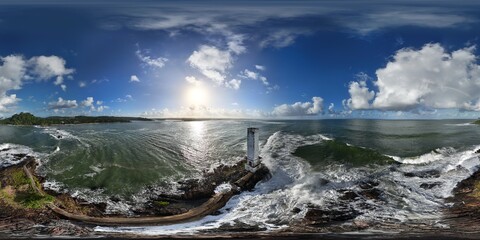 360 aerial photo taken with drone of Farol do Itacaré just before sunset