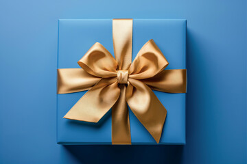 Blue gift box with gold ribbon isolated on blue background