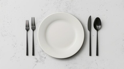 Plate with cutlery on a plain white surface