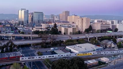 Downtown oakland, BART train and interstate 880 freeway at sunset, California, United States of...