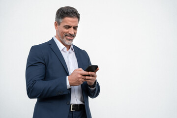 Mature businessman in suit holding cellphone isolated, white background. Smiling Latin business man...