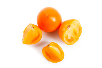 Cut and whole of yellow tomato isolated on white background.