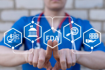Doctor working on virtual touch screen presses abbreviation: FDA. Food and Drug Administration (...