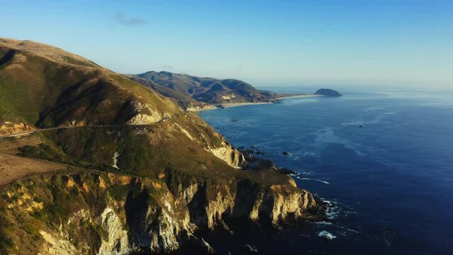 4k aerial footage of the mountains and ocean of Big Sur Natural Park, California coastline on a sunny day. Northern Pacific West Coast. Stunning views of the blue water and yellow hills of Point Sur.