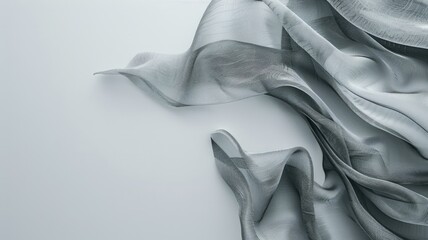 Sheer grey fabric with delicate waves on white surface