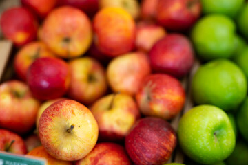 Many of fresh ripe apples on the market, puts out for sale. Close-up image