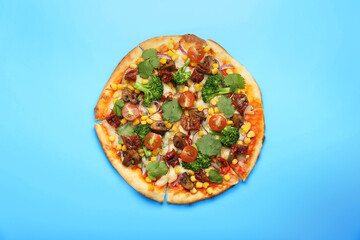 Delicious vegetarian pizza with mushrooms, vegetables and parsley on light blue background, top view