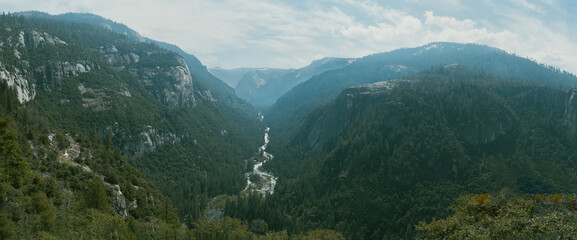 Panoramic view of Yosemite with it river, mountains and peaks.