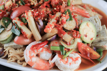 Instant noodles spicy salad with shrimp and vegetable on black table. Yum Mama Thai cuisine Yum traditional spicy hot