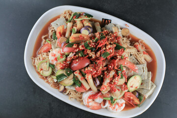 Instant noodles spicy salad with shrimp and vegetable on black table. Yum Mama Thai cuisine Yum traditional spicy hot