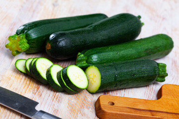 Fresh organic zucchini sliced on wooden cutting board