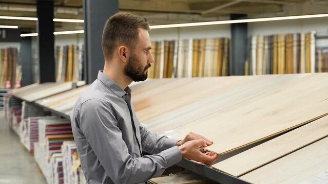 A man choosing floor laminate for his home